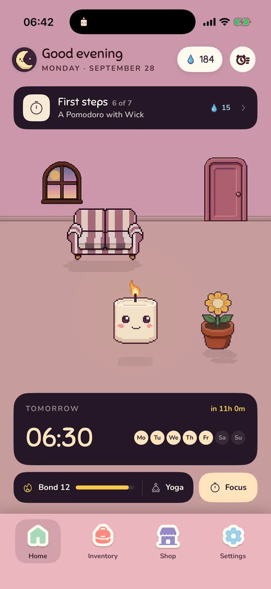 The room in the evening: golden light and a lit lamp